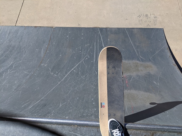 Looking down from the edge of the 4 foot quarter pipe at the local skatepark.